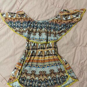 Multicolored romper with pom embroidery.